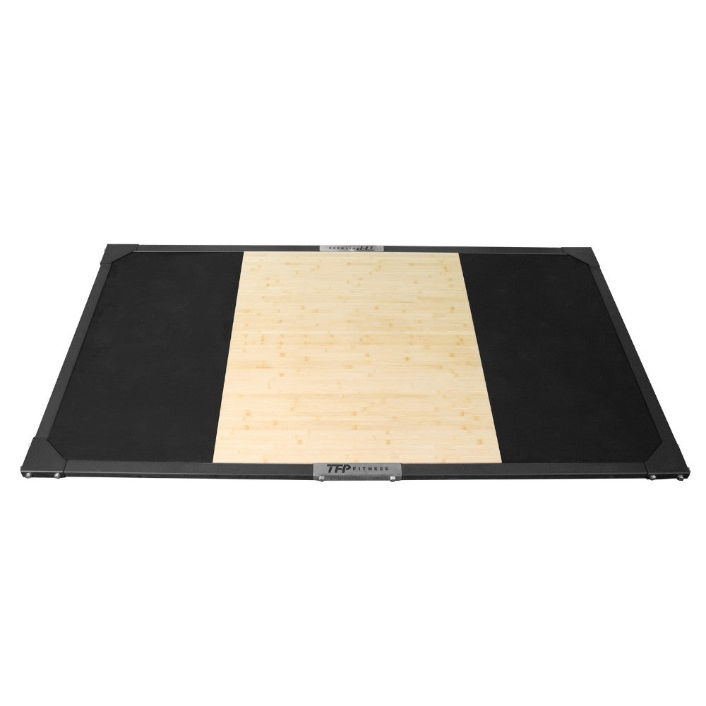A rectangular TFP Fitness weightlifting platform featuring a natural bamboo center panel flanked by black rubber mats, shown on a plain white background.