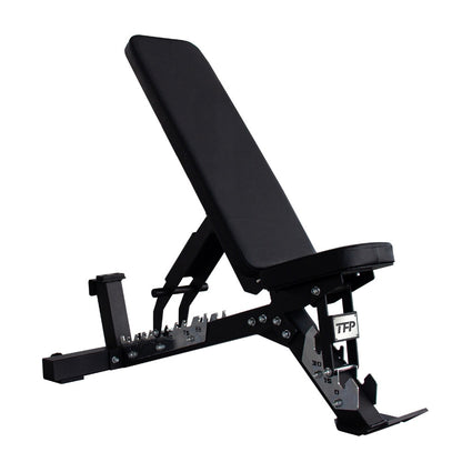 A black adjustable weight bench with a padded headrest and long inclined bench pad, shown on a plain white background. The frame is black metal with silver adjustment hardware, and the brand name TFP Fitness is visible on the leg support.
